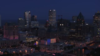 DX0002_151_001 - 5.7K aerial stock footage flyby skyscrapers and a riverfront office tower at night, Downtown Milwaukee, Wisconsin