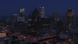 DX0002_151_002 - 5.7K aerial stock footage of a riverfront office tower at night, Downtown Milwaukee, Wisconsin