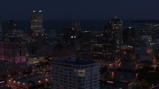 5.7K aerial stock footage of skyscrapers seen while descending by apartment high-rise at night, Downtown Milwaukee, Wisconsin Aerial Stock Footage | DX0002_151_006