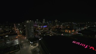 DX0002_151_014 - 5.7K aerial stock footage reverse view of high-rise apartment building and skyline at night, Downtown Milwaukee, Wisconsin