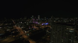 DX0002_151_018 - 5.7K aerial stock footage fly away from skyline to reveal an apartment high-rise at night, Downtown Milwaukee, Wisconsin