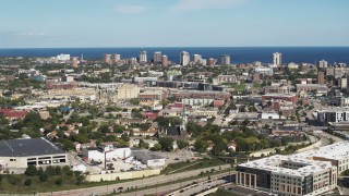 5.7K aerial stock footage of lakeside apartment buildings seen across the city while ascending in Milwaukee, Wisconsin Aerial Stock Footage | DX0002_152_027