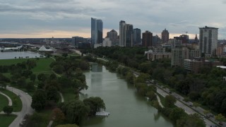 DX0002_154_033 - 5.7K aerial stock footage of the city's skyline, seen while descending over Veterans Park, Downtown Milwaukee, Wisconsin