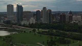 5.7K aerial stock footage a view of the city's skyline seen from park at sunset, Downtown Milwaukee, Wisconsin Aerial Stock Footage | DX0002_155_011