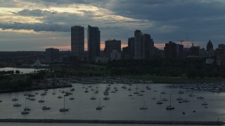 5.7K aerial stock footage the city's skyline seen while flying by marina at sunset, Downtown Milwaukee, Wisconsin Aerial Stock Footage | DX0002_155_017