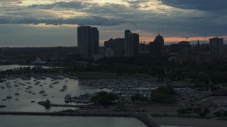 5.7K aerial stock footage of skyscrapers in the city's skyline seen from a marina at sunset, Downtown Milwaukee, Wisconsin Aerial Stock Footage | DX0002_155_023