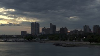 5.7K aerial stock footage of skyscrapers in the city's skyline seen while ascending past the marina at twilight, Downtown Milwaukee, Wisconsin Aerial Stock Footage | DX0002_155_024