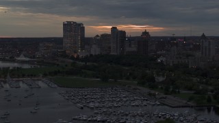 5.7K aerial stock footage pass and fly away from the city's skyline at twilight, Downtown Milwaukee, Wisconsin Aerial Stock Footage | DX0002_155_034