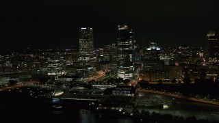 5.7K aerial stock footage of passing by tall skyscrapers at night, Downtown Milwaukee, Wisconsin Aerial Stock Footage | DX0002_157_003