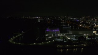 DX0002_157_011 - 5.7K aerial stock footage fly away from Discovery World museum at night, Downtown Milwaukee, Wisconsin