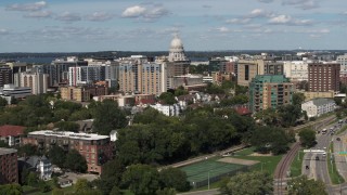 5.7K aerial stock footage flyby and away from apartment buildings and capitol dome in Madison, Wisconsin Aerial Stock Footage | DX0002_158_009