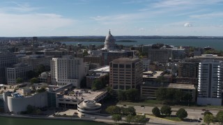 5.7K aerial stock footage reverse view of capitol dome, office buildings, seen from lake, Madison, Wisconsin Aerial Stock Footage | DX0002_158_034