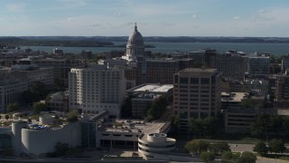 5.7K aerial stock footage pass by convention center and office buildings and focus on the capitol building in Madison, Wisconsin Aerial Stock Footage | DX0002_160_018