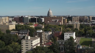 5.7K aerial stock footage of flying by apartment buildings with a view of the capitol building in Madison, Wisconsin Aerial Stock Footage | DX0002_160_021