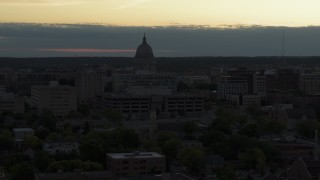 5.7K aerial stock footage reveal smoke stacks while flying away from the capitol dome at sunset, Madison, Wisconsin Aerial Stock Footage | DX0002_162_005