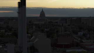 5.7K aerial stock footage descend and flyby the capitol dome at sunset, reveal smoke stacks Madison, Wisconsin Aerial Stock Footage | DX0002_162_007