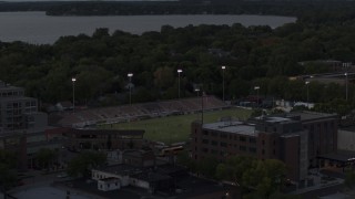 DX0002_162_009 - 5.7K aerial stock footage of orbiting a soccer stadium at twilight, Madison, Wisconsin