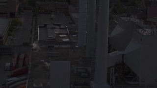 5.7K aerial stock footage of circling smoke stacks at a power plant at twilight, Madison, Wisconsin Aerial Stock Footage | DX0002_162_014