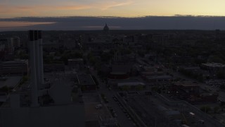 5.7K aerial stock footage flyby and away from the capitol dome and power plant smoke stacks at twilight, Madison, Wisconsin Aerial Stock Footage | DX0002_162_015