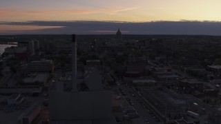 5.7K aerial stock footage the capitol dome seen while passing power plant smoke stacks at twilight, Madison, Wisconsin Aerial Stock Footage | DX0002_162_017