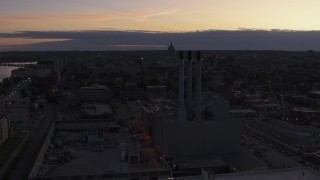 5.7K aerial stock footage focus on capitol dome while passing power plant smoke stacks at twilight, Madison, Wisconsin Aerial Stock Footage | DX0002_162_018