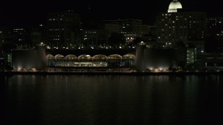 DX0002_162_060 - 5.7K aerial stock footage fly away from convention center at night, reveal capitol, Madison, Wisconsin