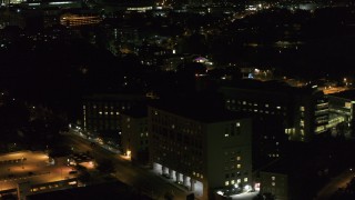 5.7K aerial stock footage orbit a hospital complex and flyby parking garage at night, Madison, Wisconsin Aerial Stock Footage | DX0002_163_020