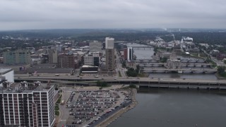 5.7K aerial stock footage slow approach to apartment high-rise and office buildings near bridges and river, Downtown Cedar Rapids, Iowa Aerial Stock Footage | DX0002_164_003