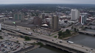 5.7K aerial stock footage fly away from convention center, city buildings near river, Downtown Cedar Rapids, Iowa Aerial Stock Footage | DX0002_164_005