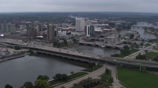 DX0002_164_008 - 5.7K aerial stock footage approach and flyby bridges spanning the river beside Downtown Cedar Rapids, Iowa