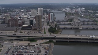 DX0002_164_010 - 5.7K aerial stock footage approach apartment high-rise and bridges spanning the river, Downtown Cedar Rapids, Iowa