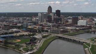 DX0002_165_020 - 5.7K aerial stock footage a slow approach to the city's skyline across the river, Downtown Des Moines, Iowa