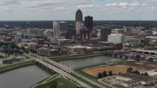 5.7K aerial stock footage fly away from the city's skyline and bridges over the river, Downtown Des Moines, Iowa Aerial Stock Footage | DX0002_165_022