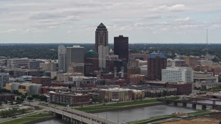 DX0002_165_031 - 5.7K aerial stock footage of flying by the Cedar River while focused on skyline of Downtown Des Moines, Iowa