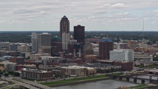 DX0002_165_032 - 5.7K aerial stock footage of passing the Cedar River while focused on skyline of Downtown Des Moines, Iowa