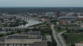 DX0002_167_011 - 5.7K aerial stock footage of bridges over Cedar River by the arena in Downtown Des Moines, Iowa