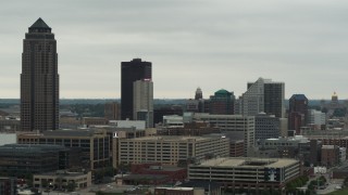 DX0002_167_015 - 5.7K aerial stock footage of flying by a towering skyscraper and office buildings in Downtown Des Moines, Iowa