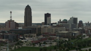 DX0002_167_017 - 5.7K aerial stock footage ascend with a view of a towering skyscraper and office buildings in Downtown Des Moines, Iowa