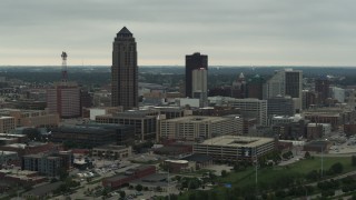 DX0002_167_018 - 5.7K aerial stock footage flying by a towering skyscraper and office buildings in Downtown Des Moines, Iowa