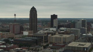 DX0002_167_019 - 5.7K aerial stock footage passing by a towering skyscraper and office buildings in Downtown Des Moines, Iowa