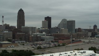 DX0002_167_025 - 5.7K aerial stock footage of passing by office buildings near the skyscraper in Downtown Des Moines, Iowa