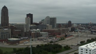 DX0002_167_027 - 5.7K aerial stock footage flyby office buildings near the skyscraper in Downtown Des Moines, Iowa, capitol in distance