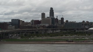 5.7K aerial stock footage ascend from Missouri River toward the city skyline, Downtown Omaha, Nebraska Aerial Stock Footage | DX0002_168_014