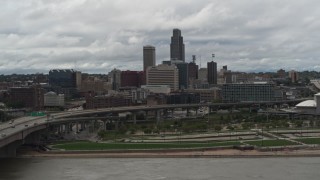 DX0002_168_017 - 5.7K aerial stock footage of the city skyline and park across the river, Downtown Omaha, Nebraska