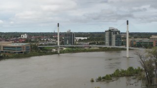 DX0002_168_021 - 5.7K aerial stock footage of flying by a pedestrian bridge spanning the Missouri River, Omaha, Nebraska