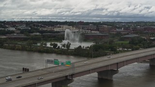 DX0002_168_024 - 5.7K aerial stock footage of a fountain in a riverfront park on the other side of the river, Omaha, Nebraska