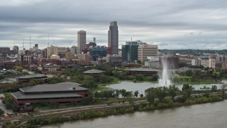 DX0002_169_029 - 5.7K aerial stock footage a view of the city's skyline behind a park fountain, Downtown Omaha, Nebraska