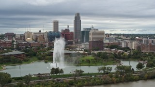 5.7K aerial stock footage of the city's skyline while flying by a park fountain, Downtown Omaha, Nebraska Aerial Stock Footage | DX0002_169_030