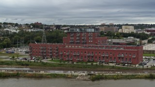 5.7K aerial stock footage descend and orbit a riverfront apartment complex, Downtown Omaha, Nebraska Aerial Stock Footage | DX0002_169_033