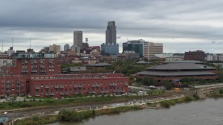 5.7K aerial stock footage of the city's skyline and riverfront apartment complex seen from river, Downtown Omaha, Nebraska Aerial Stock Footage | DX0002_169_035